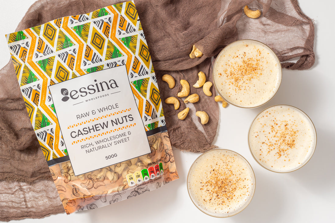 3 cups of vegan virgin eggnog image next to essina wholefoods cashew bag and some cashew nuts strewn on the table