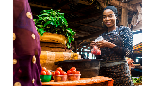 Image of African lady trading food products at a market